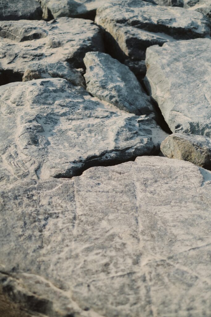 Texture-rich close-up of rough gray rocks showing natural patterns.